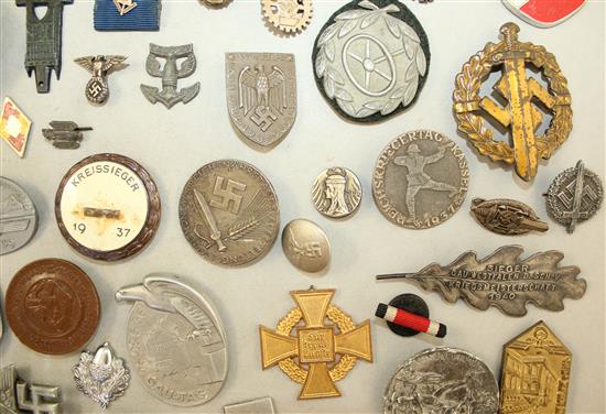 A large collection of various German Third Reich badges,